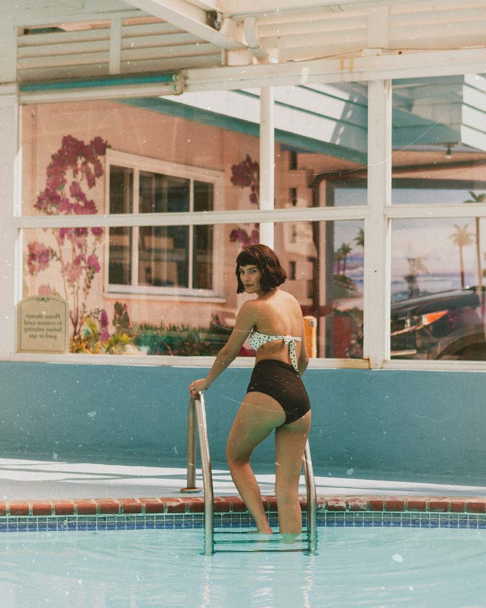 person woman standing on pool ladder at daytime human