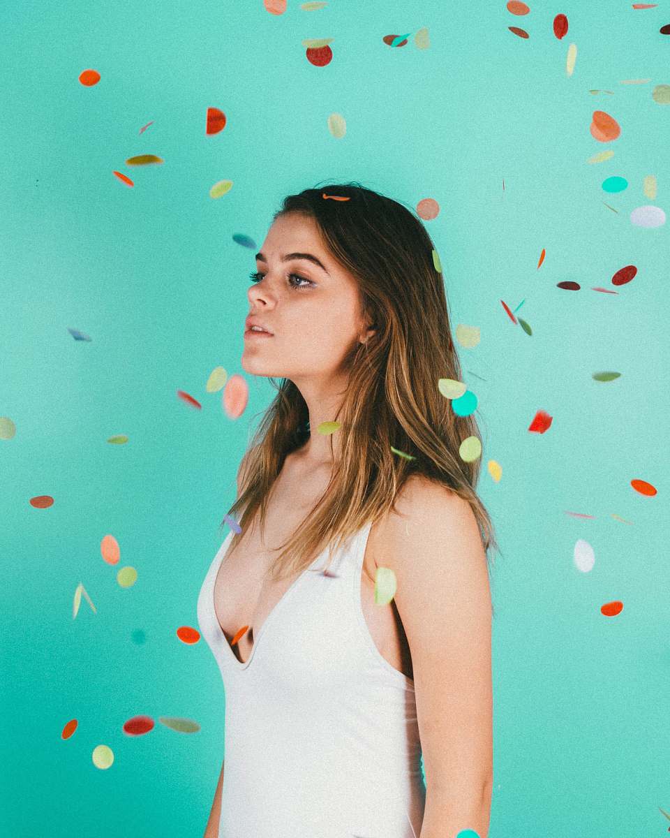 confetti woman standing surrounded with confetti paper