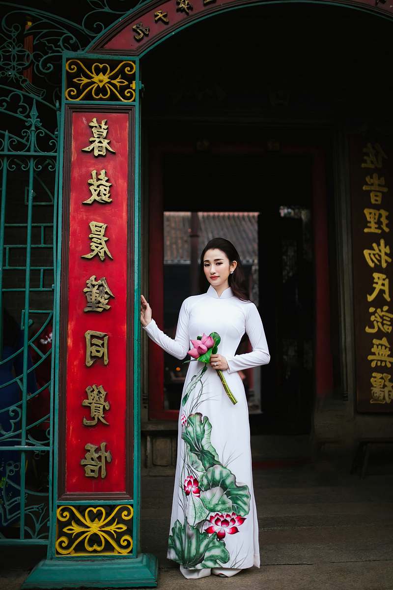 human woman standing while holding flowers person