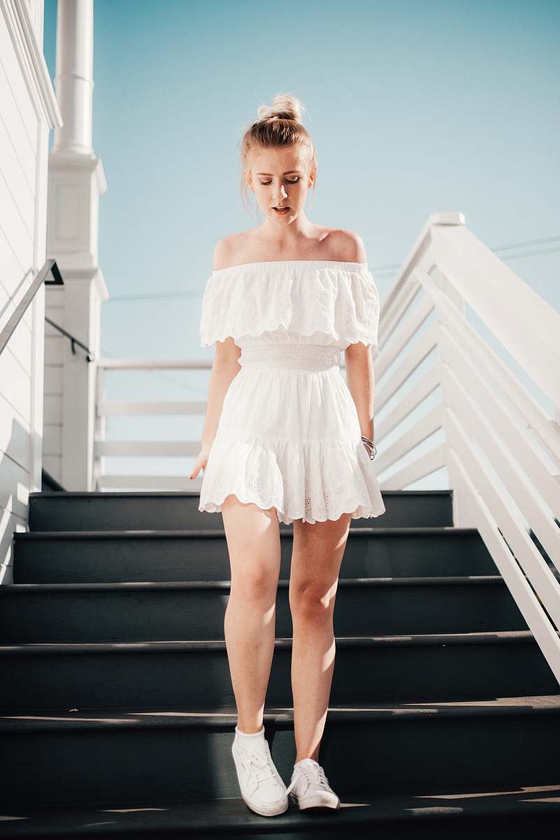 person woman walking down stair under clear blue sky during daytime human