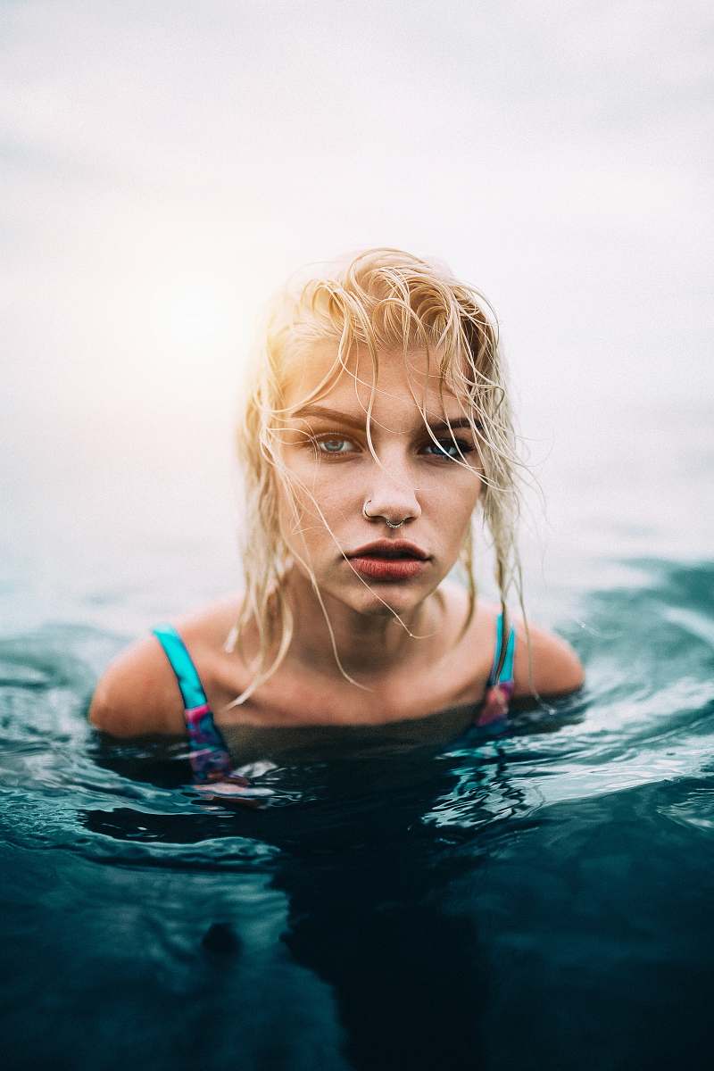 female woman wearing blue swimsuit on the body of water woman
