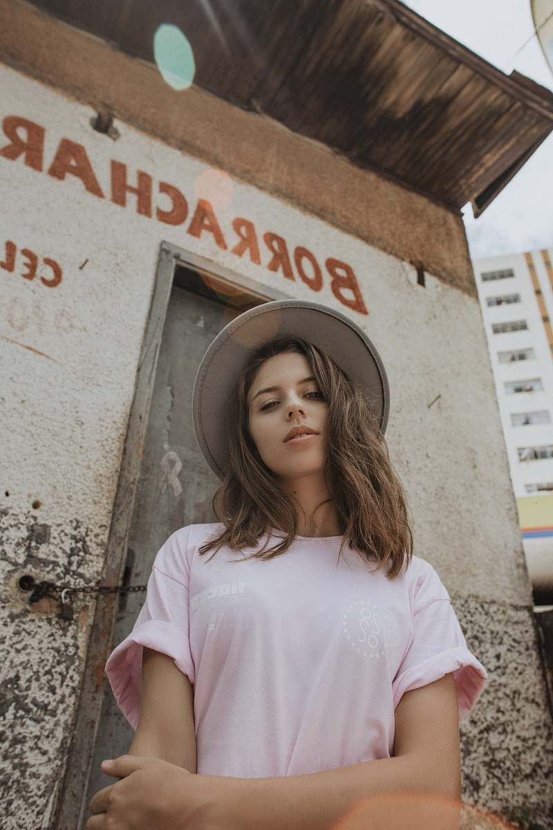 person woman wearing pink t-shirt and cap human
