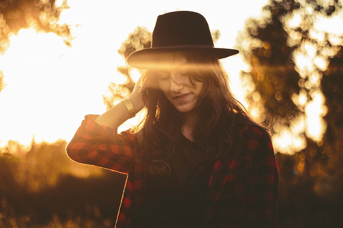 woman woman wearing red and black checked top and black hat hat
