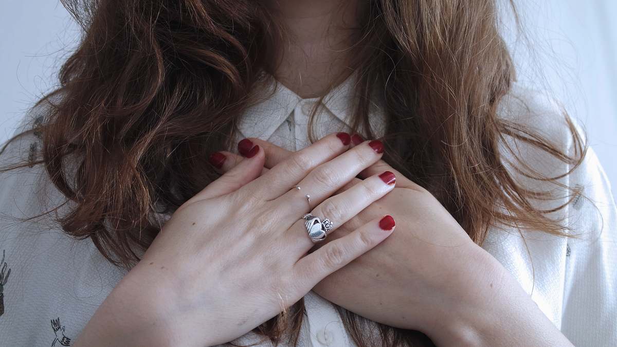 person woman wearing silver-colored ring hands
