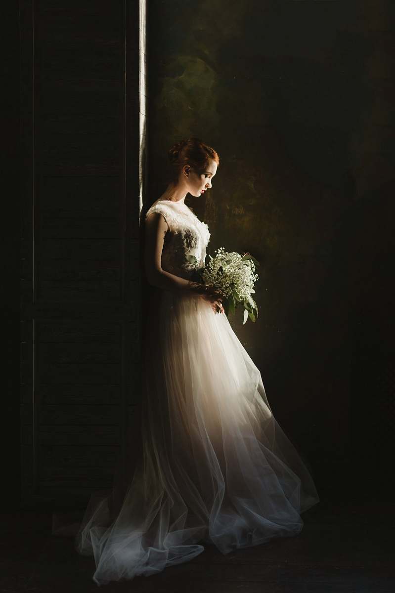 wedding woman wearing wedding gown white holding bouquet portrait