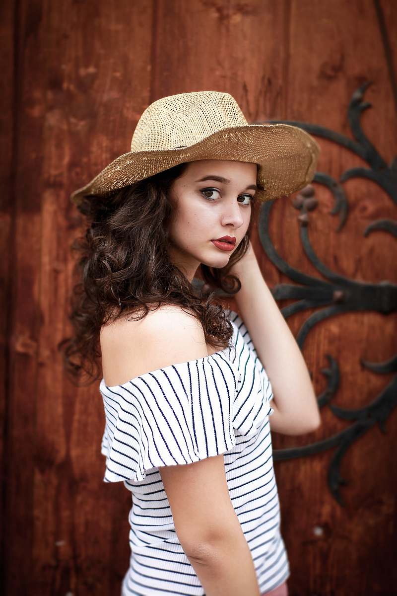 human woman wearing white and black striped top hat