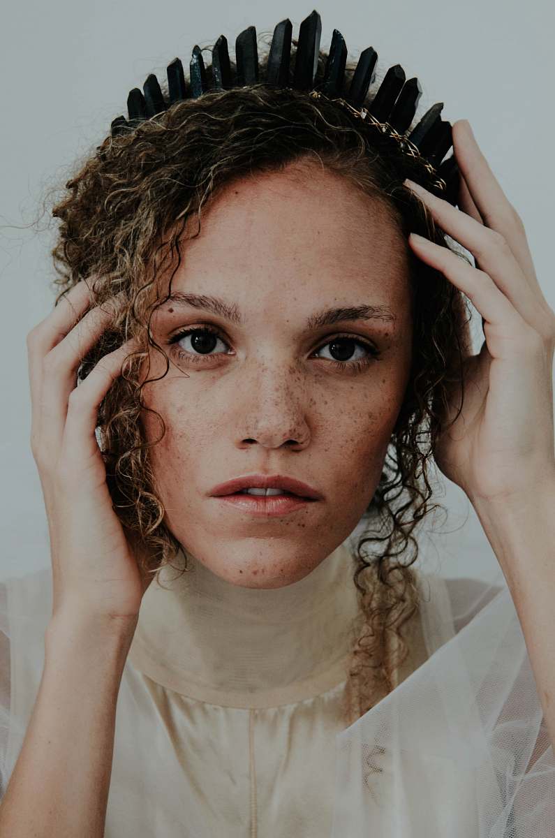 human woman wearing white dress holding black crown person