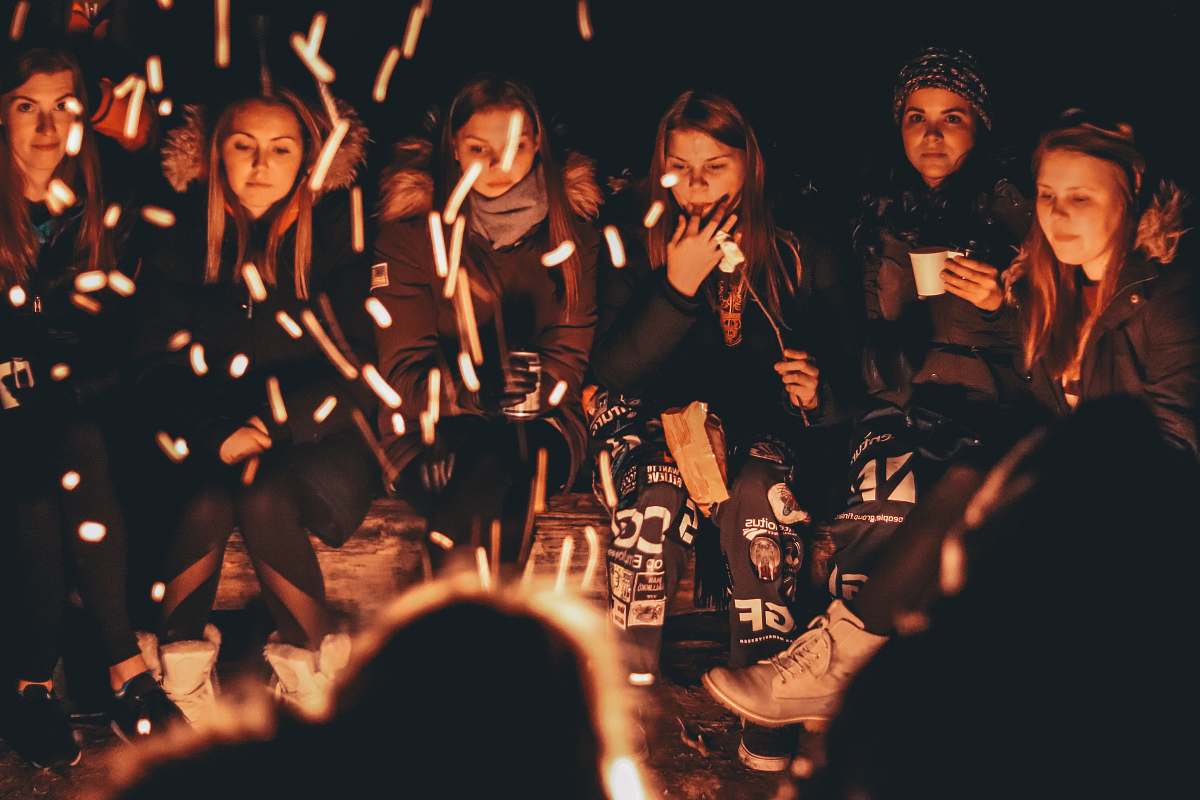 person women near bonfire at night human