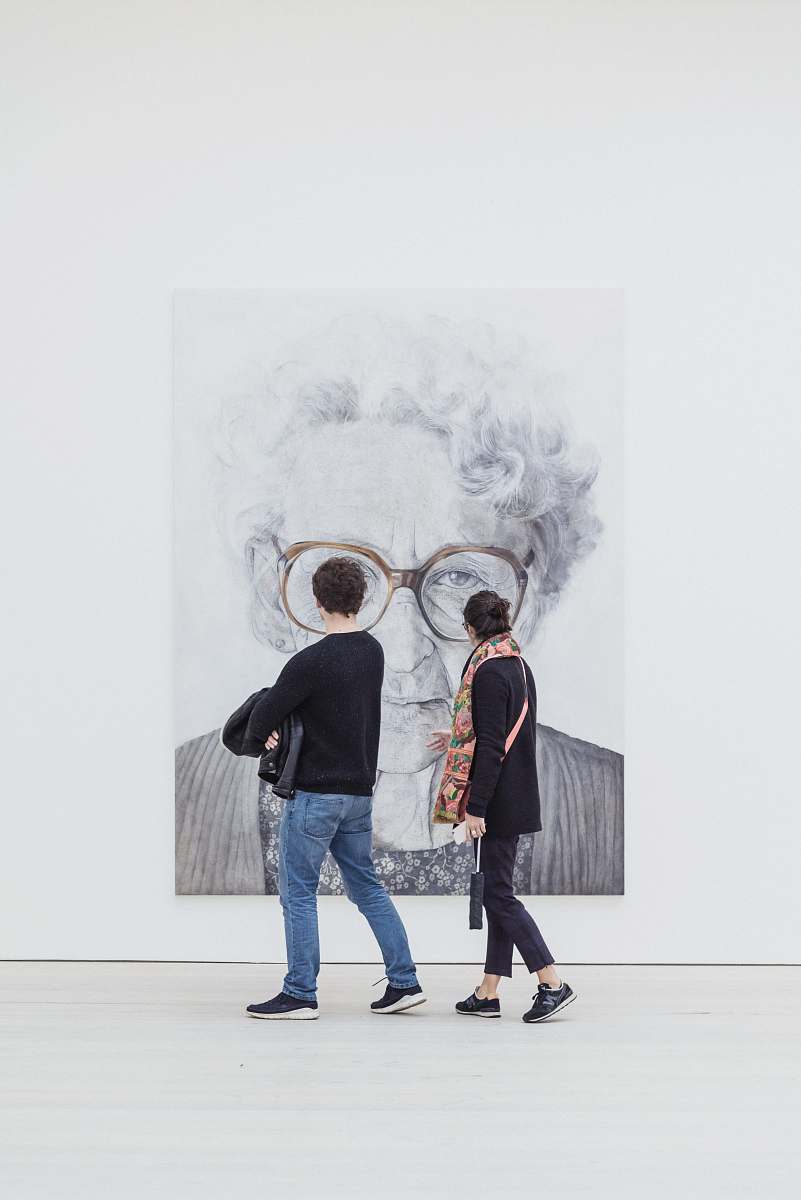 people man and woman looking at woman's painting human