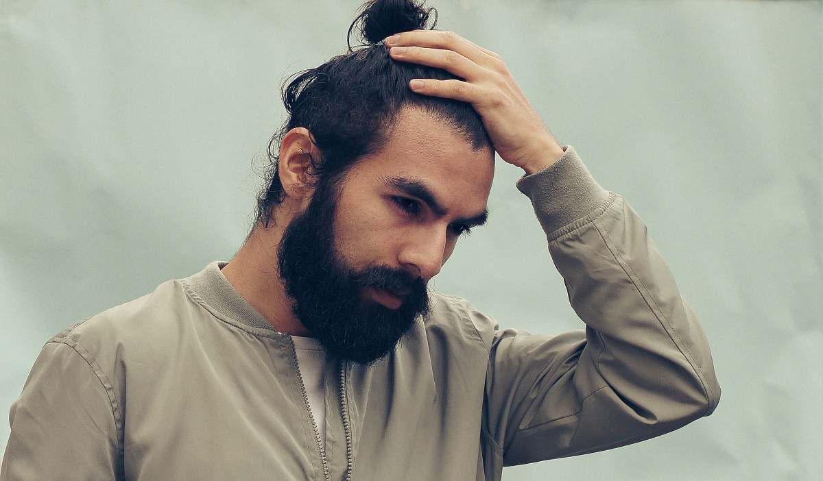 people man holding his black hair human