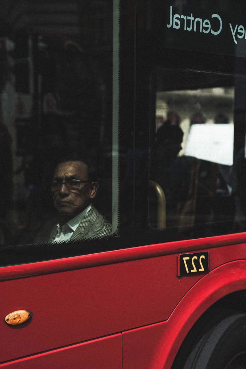 people man sitting near vehicle window at daytime london