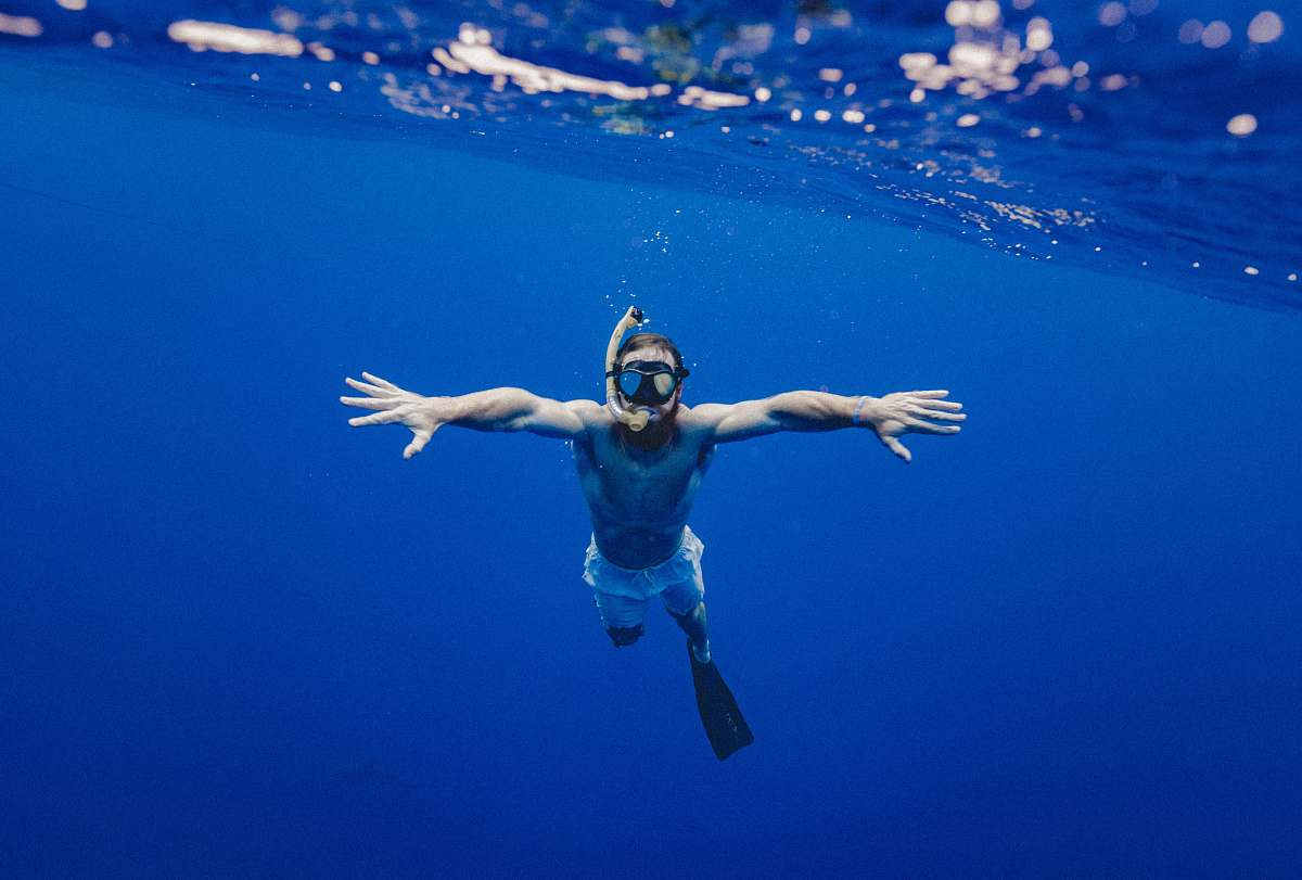 people man snorkling underwater blue