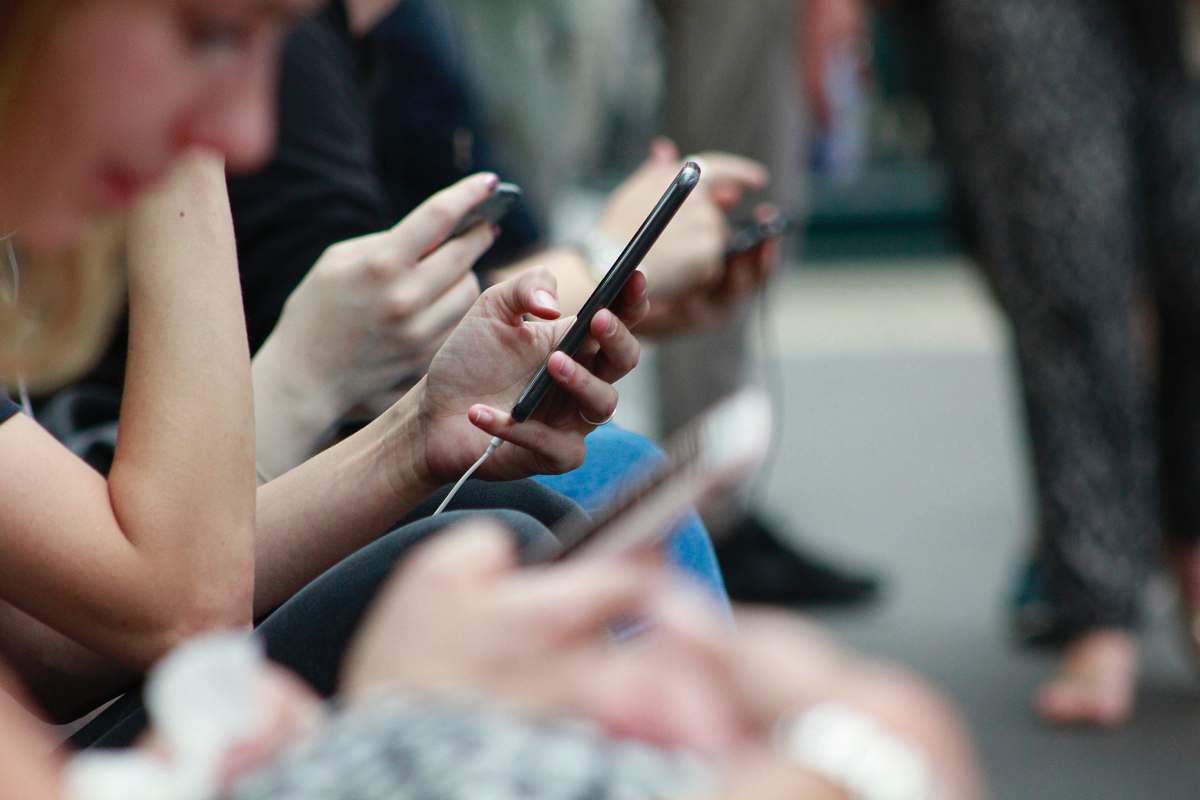 people person holding black phone human
