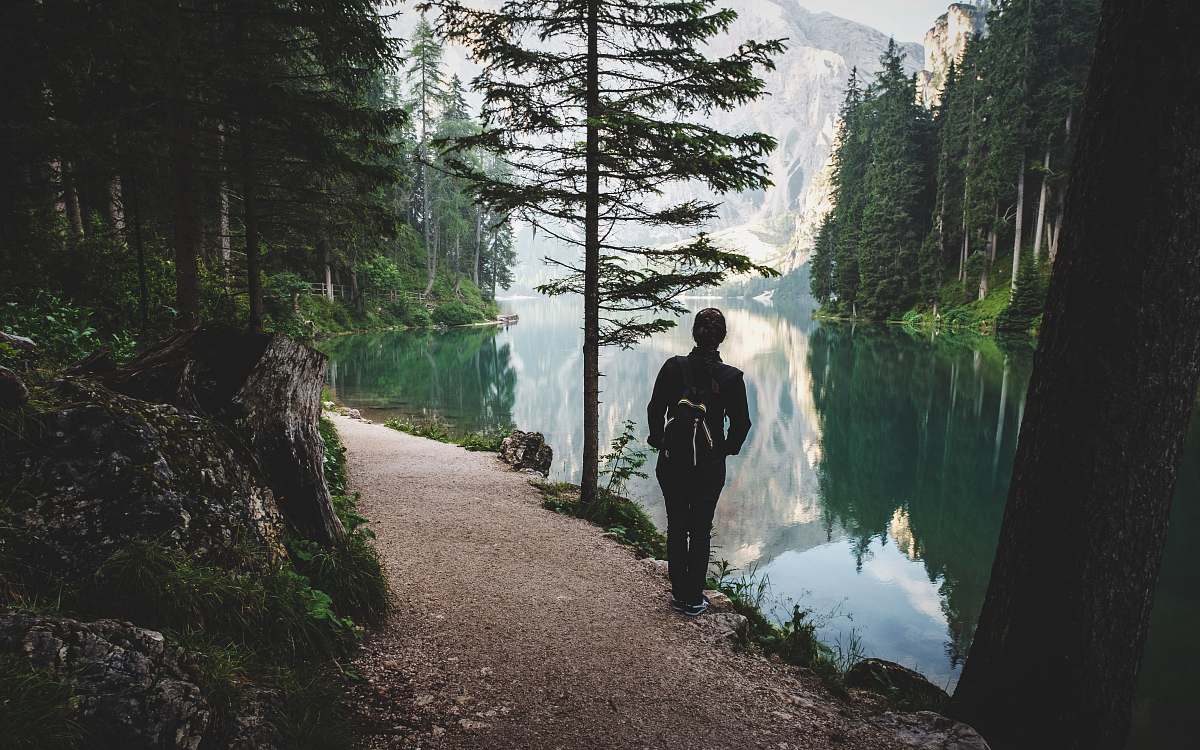 people person stands near lake nature