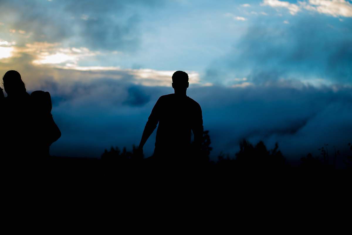 people silhouette of person walking towers trees silhouette