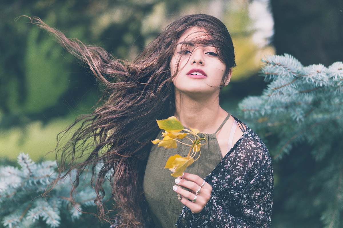 people woman holding green plant in shallow focus photography human