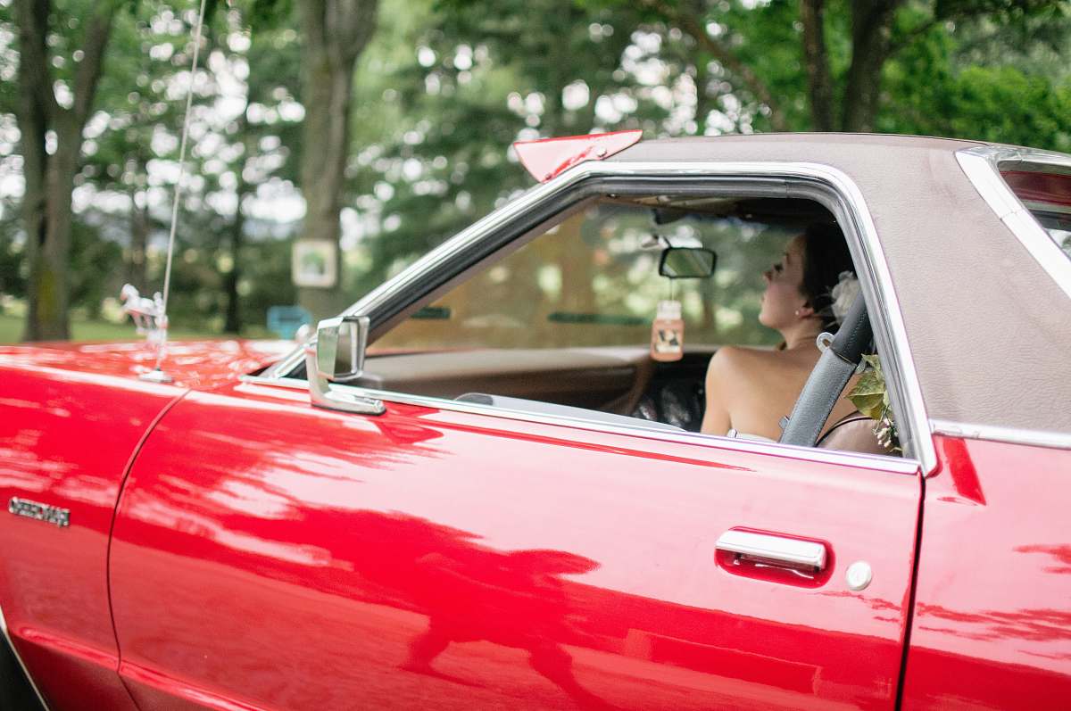people woman riding on red coupe automobile