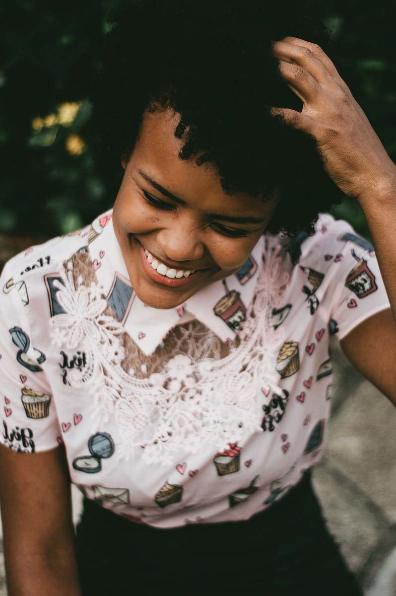 people woman touching her hair while smiling human