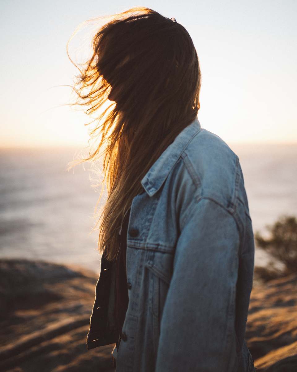 people woman wearing blue button-up denim jacket sunlight