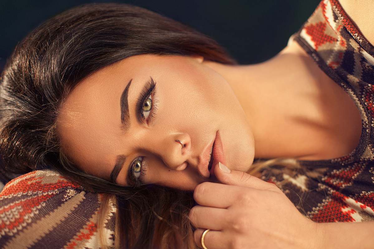 people woman wearing red, white, and black aztec top portrait