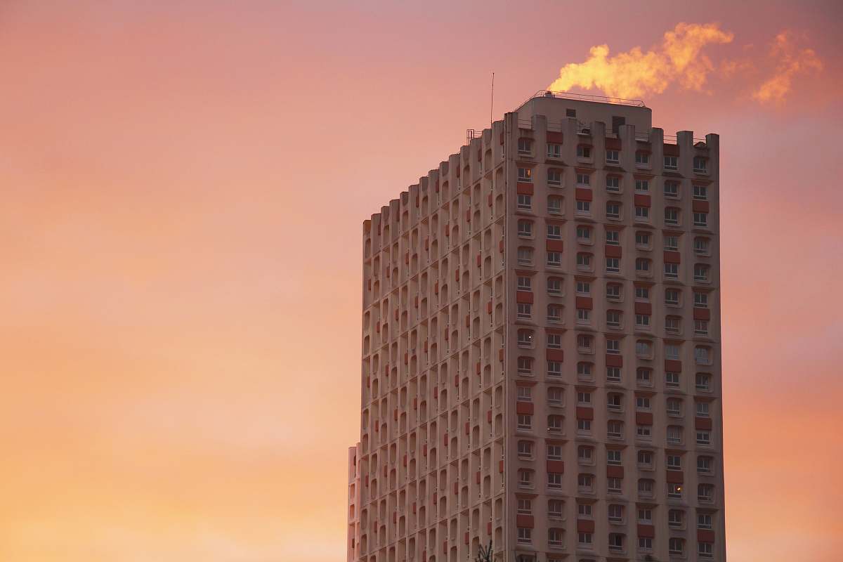  gray building under orange sky 
