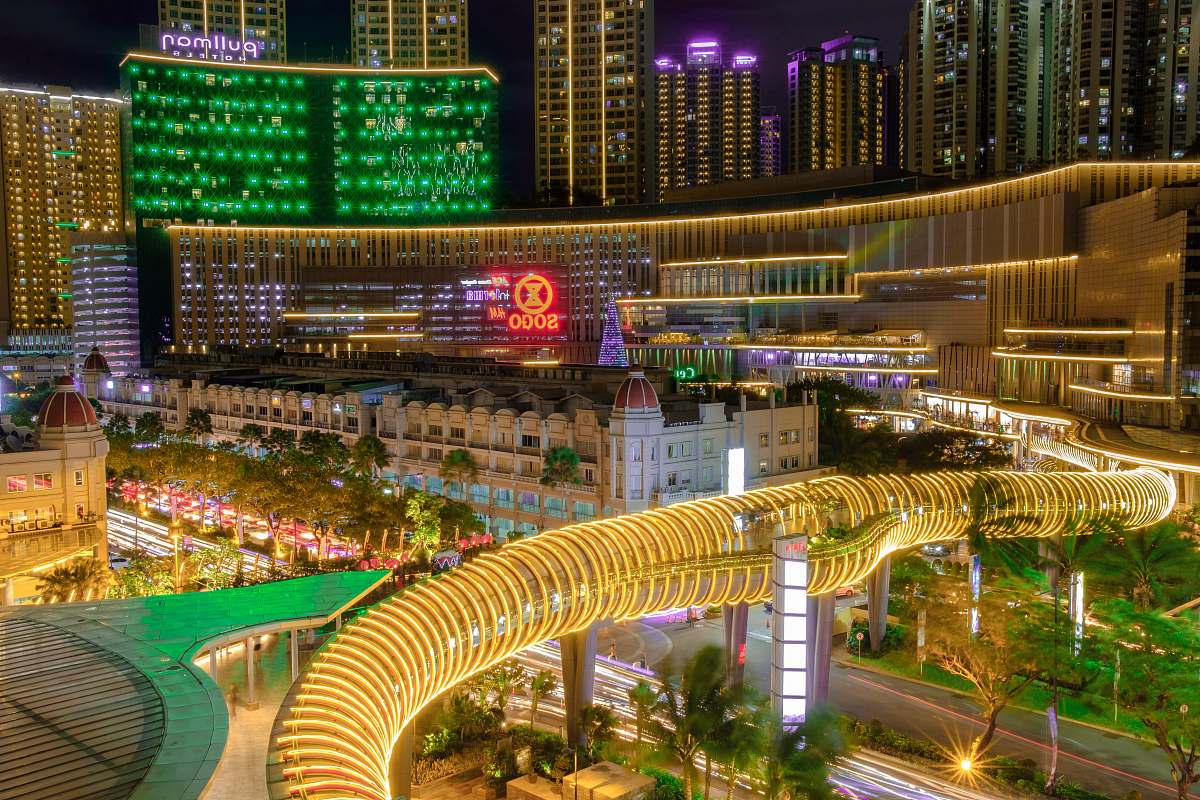 dinosaur building with gold tunnel bridge during night reptile