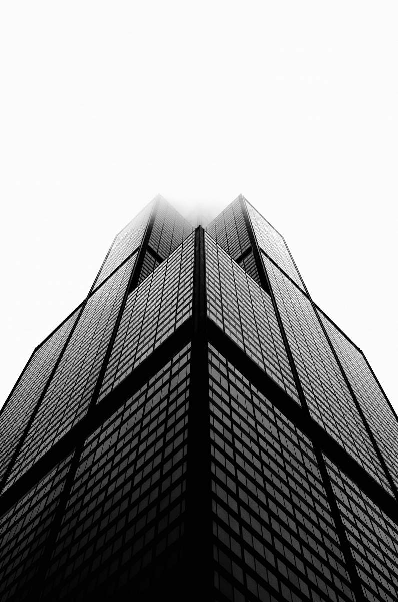 black-and-white aerial photo of building under white sky skyscraper