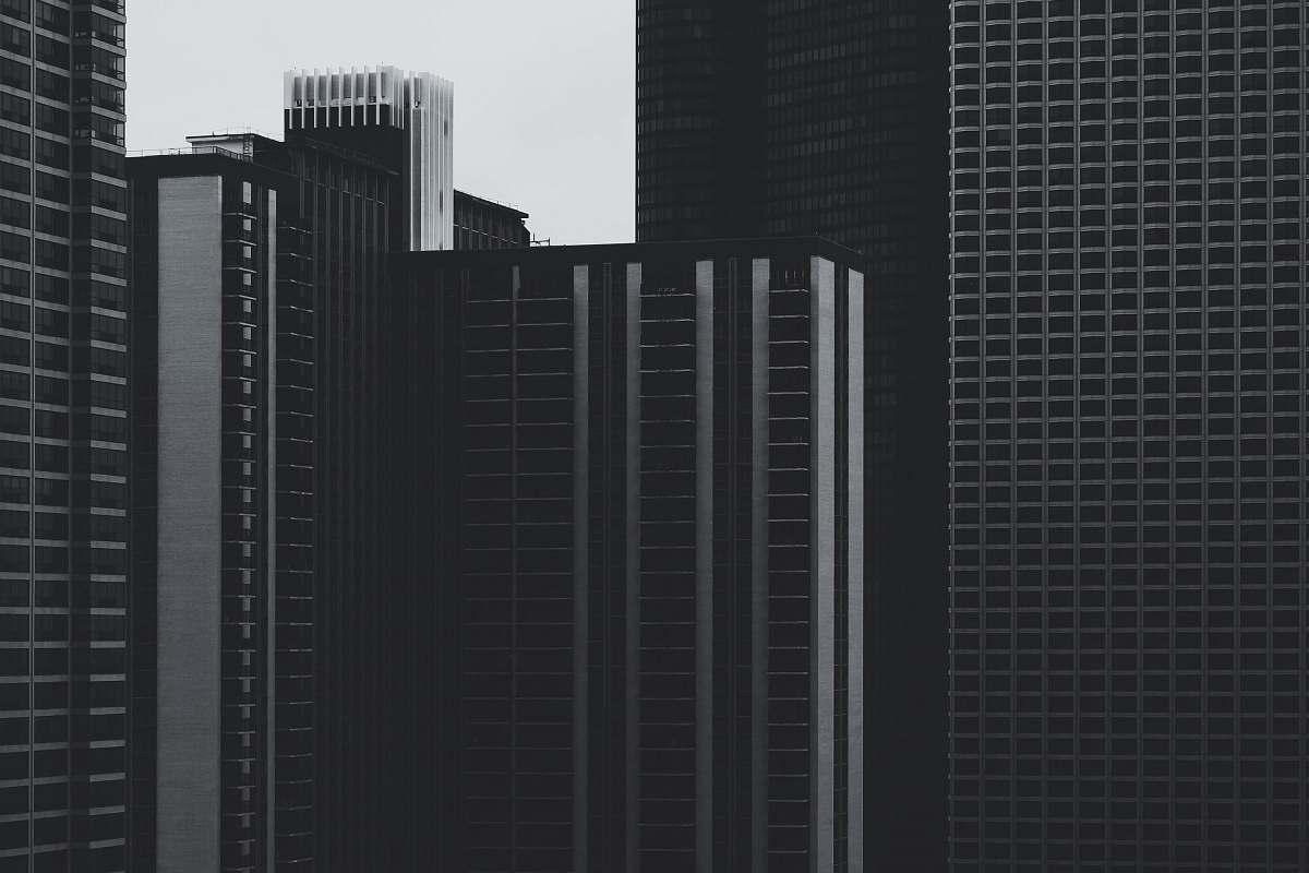 Explore the captivating beauty of urban architecture through this striking black and white photograph. The image showcases a dynamic cityscape filled with unique buildings that highlight modern design and historical influences. Ideal for use in articles, presentations, or as a backdrop for design portfolios, this photograph captures the essence of metropolitan life, making it perfect for architects, urban planners, and art enthusiasts alike.