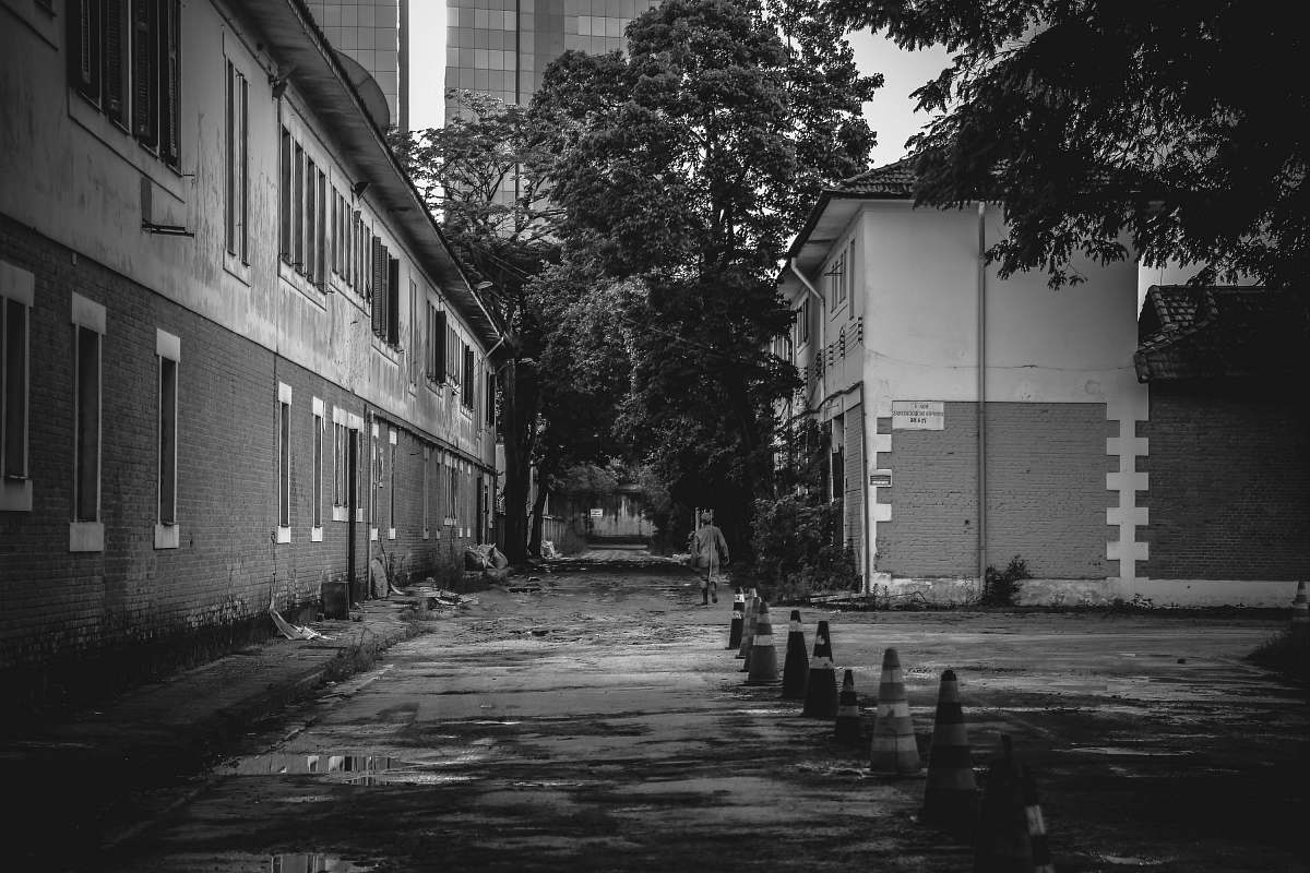 city greyscale photo of empty pathway near building during daytime building