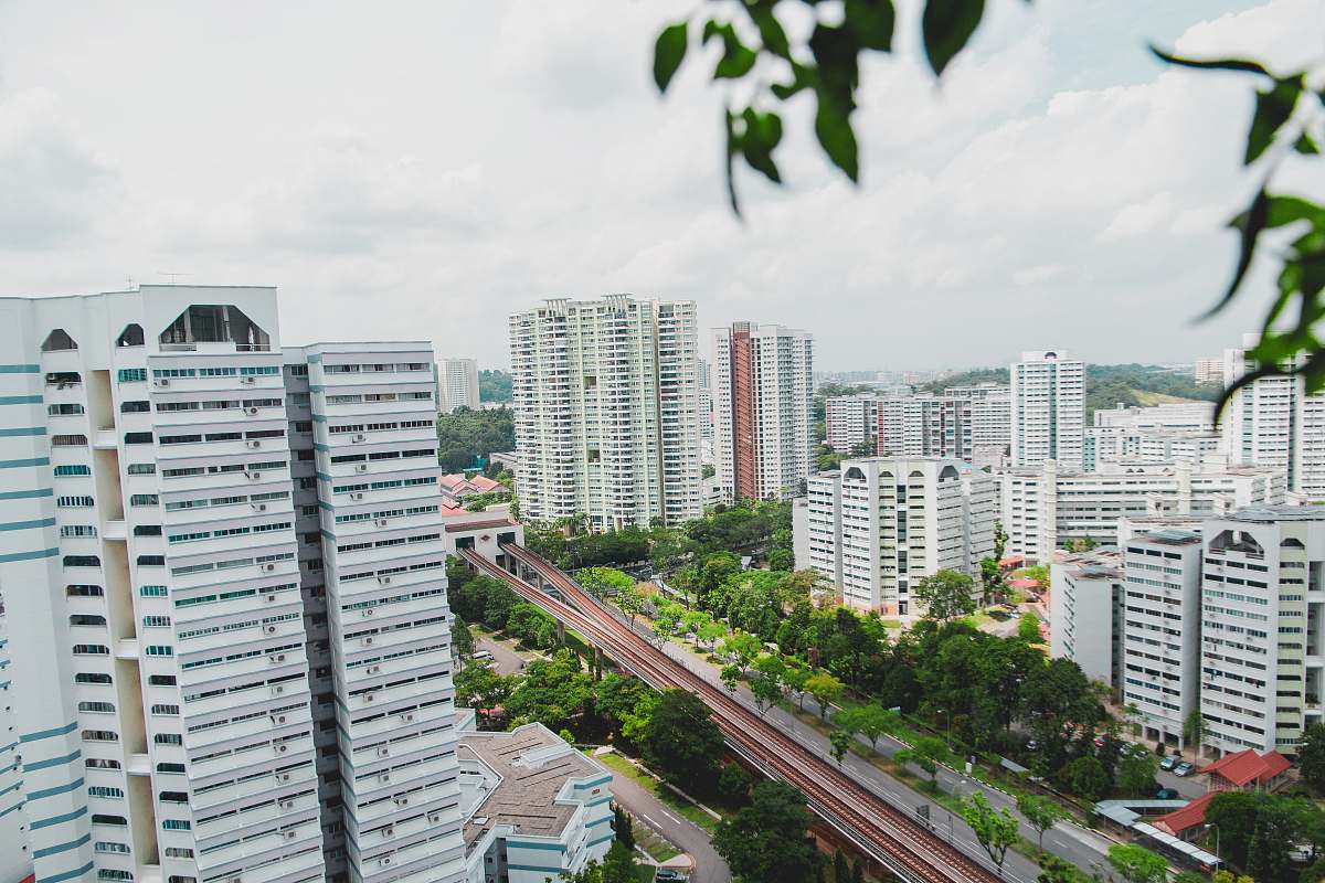 city aerial photo of buildings under cloudy sky high rise