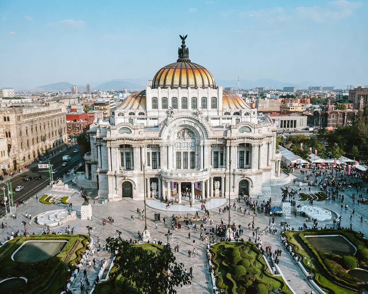 city aerial photo of people walking near white concrete dome building during daytime downtown