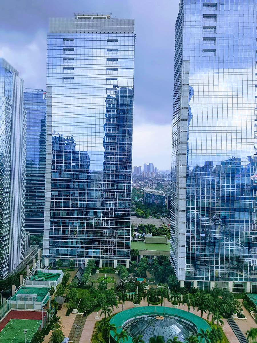 city aerial photography of city with high-rise buildings under blue and white sky during daytime high rise