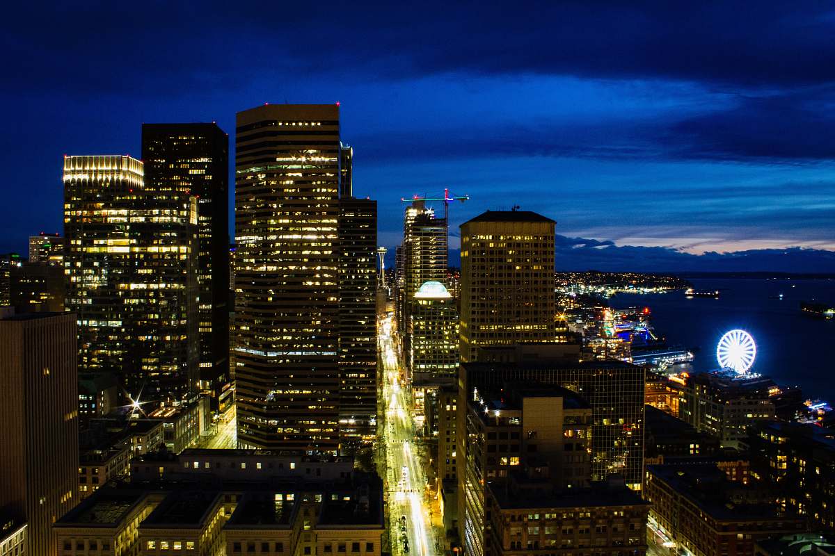 city aerial photography of lighted buildings during night time town