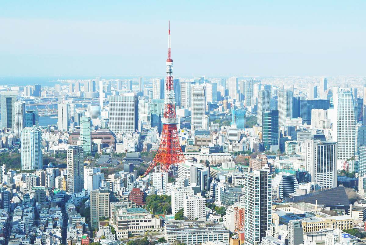 city aerial photography of red tower surrounded by buildings during daytime urban