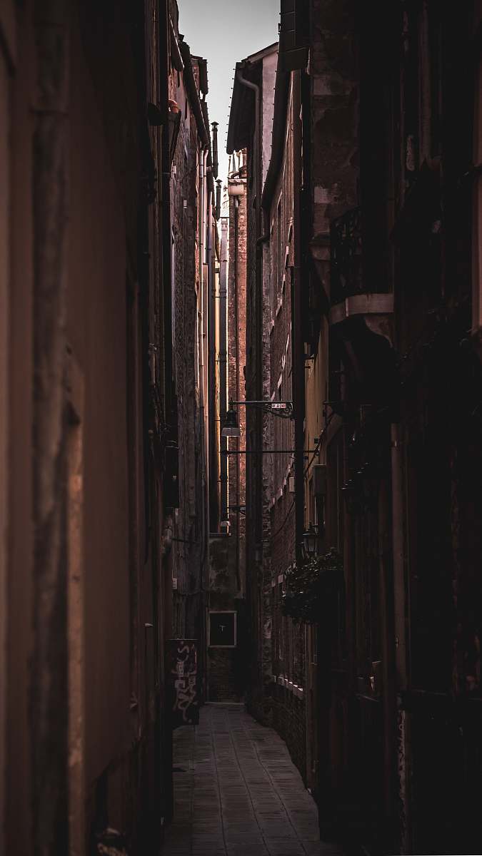 city alley in middle of buildings during daytime road