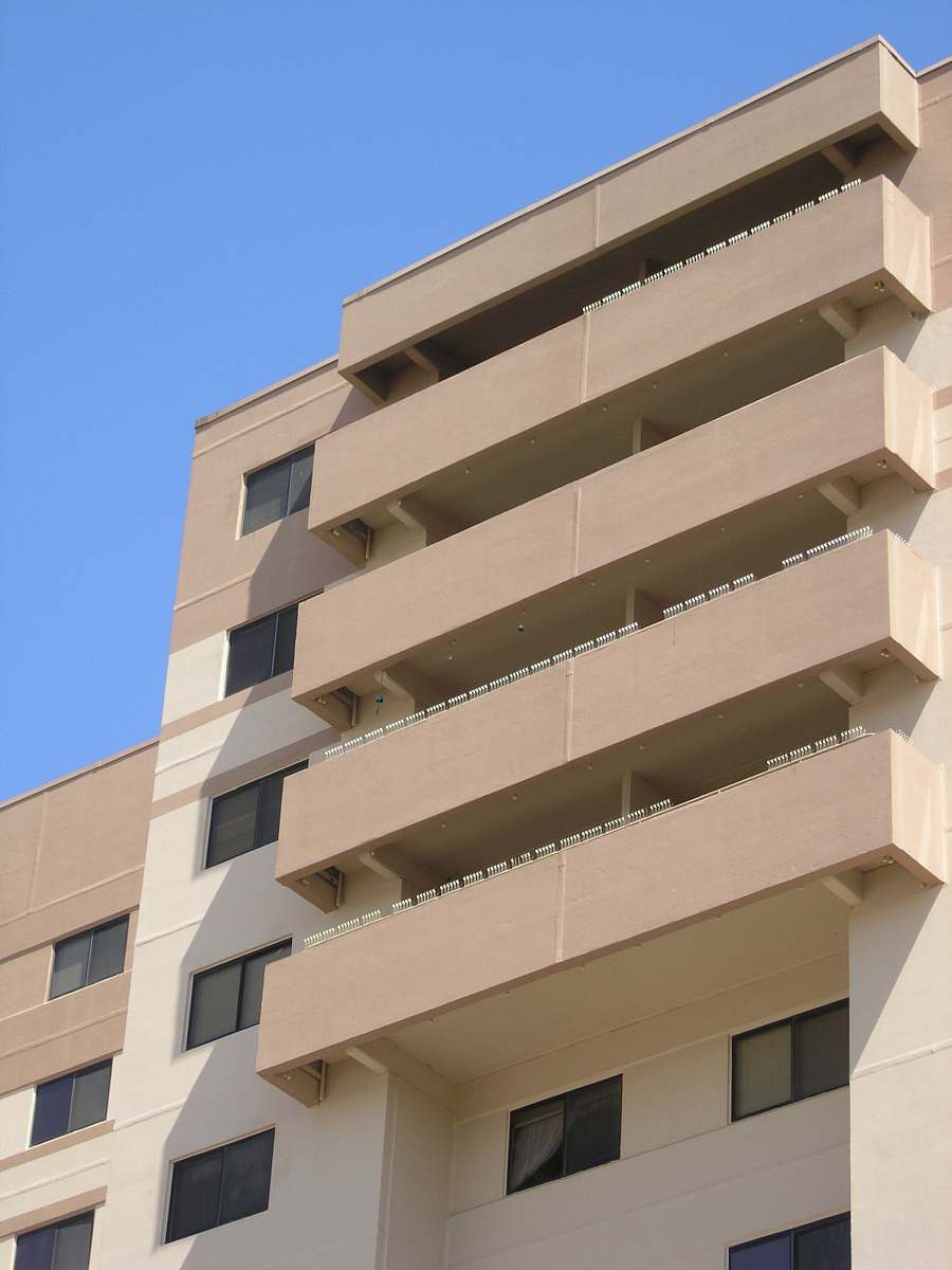 city architectural photo of a beige building high rise
