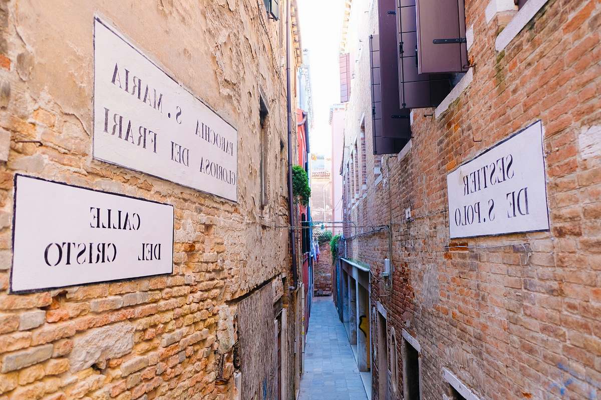 city assorted white-and-black signs on alleyway during daytime road