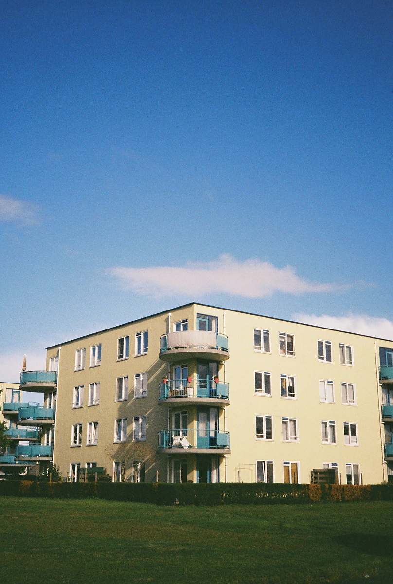 city beige concrete building under blue sky during daytime high rise