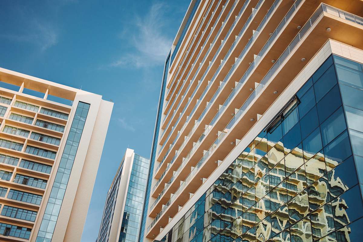 city beige curtain building in low-angle photography high rise