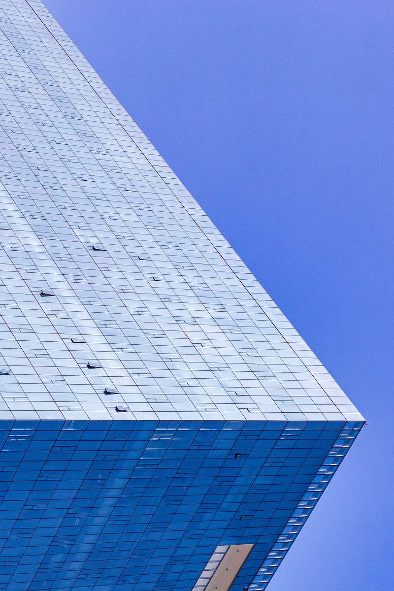 city blue glass walled high-rise building town