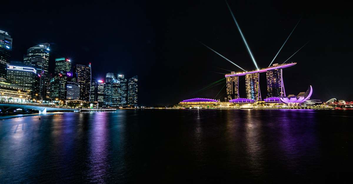 city body of water across city buildings during nighttime metropolis