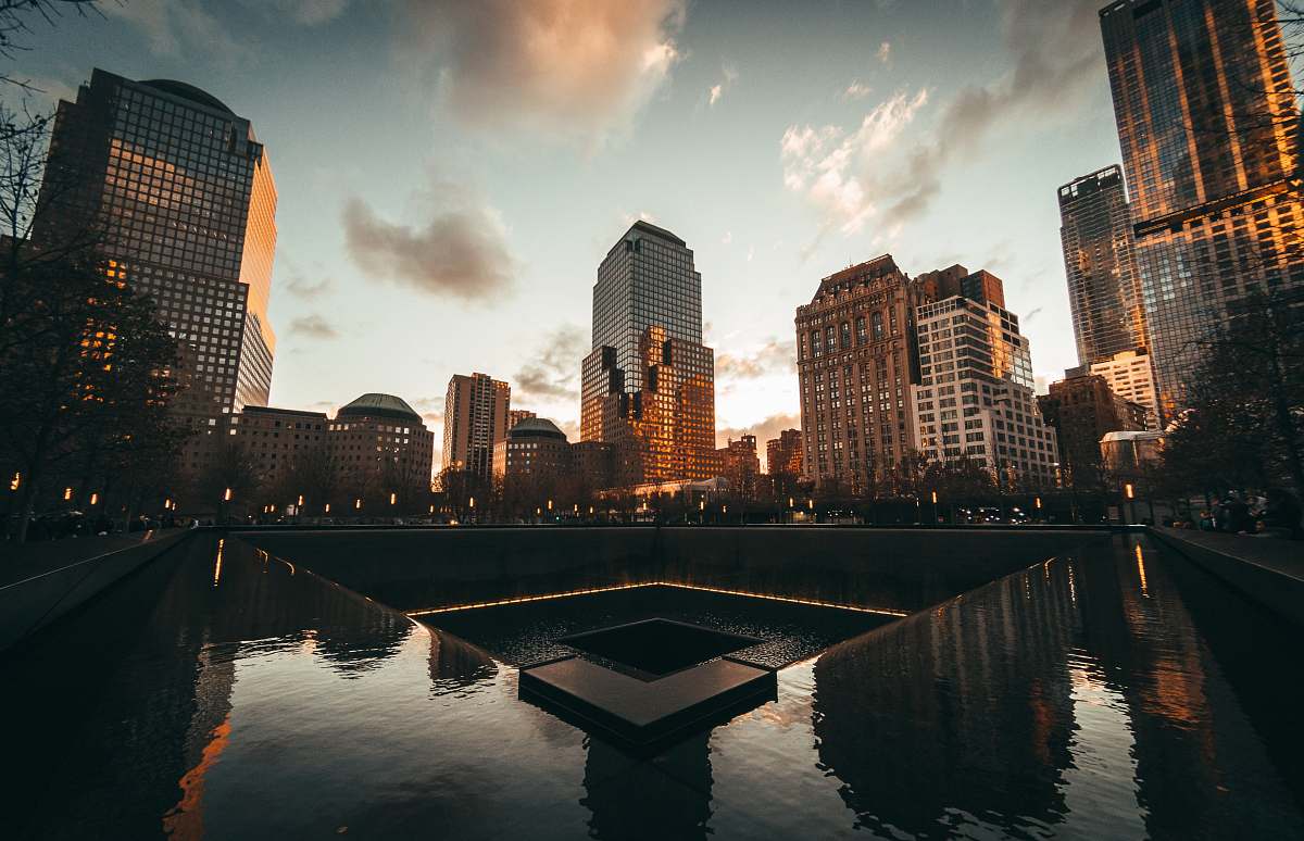 city body of water near high rise buildings during golden hour urban