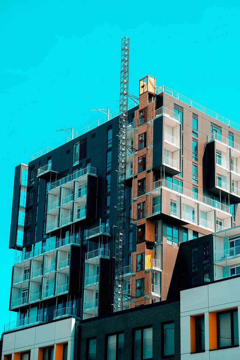 city brown and black concrete building during daytime high rise