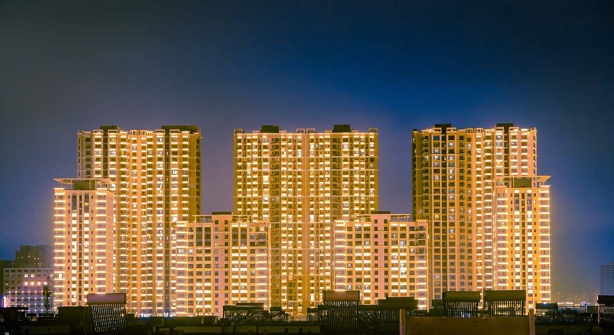 city brown concrete buildings at night high rise