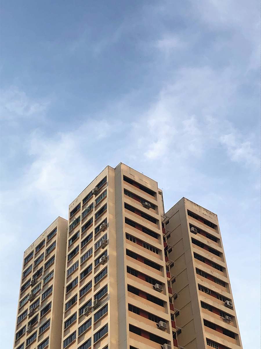 city brown concrete buildings under blue sky high rise