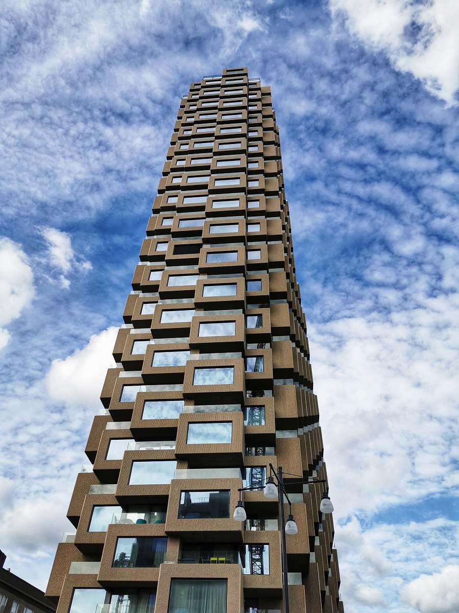 condo brown concrete high-rise building during daytime housing