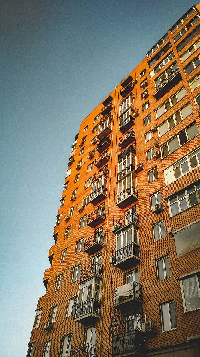 urban brown concrete high-rise building during daytime town