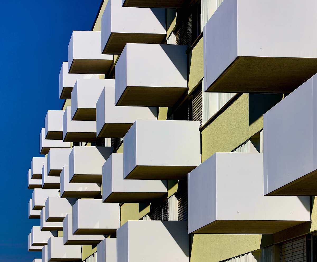 city building blocks under clear blue sky at daytime high rise