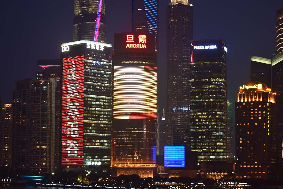 city building lot during nighttime with lights office building