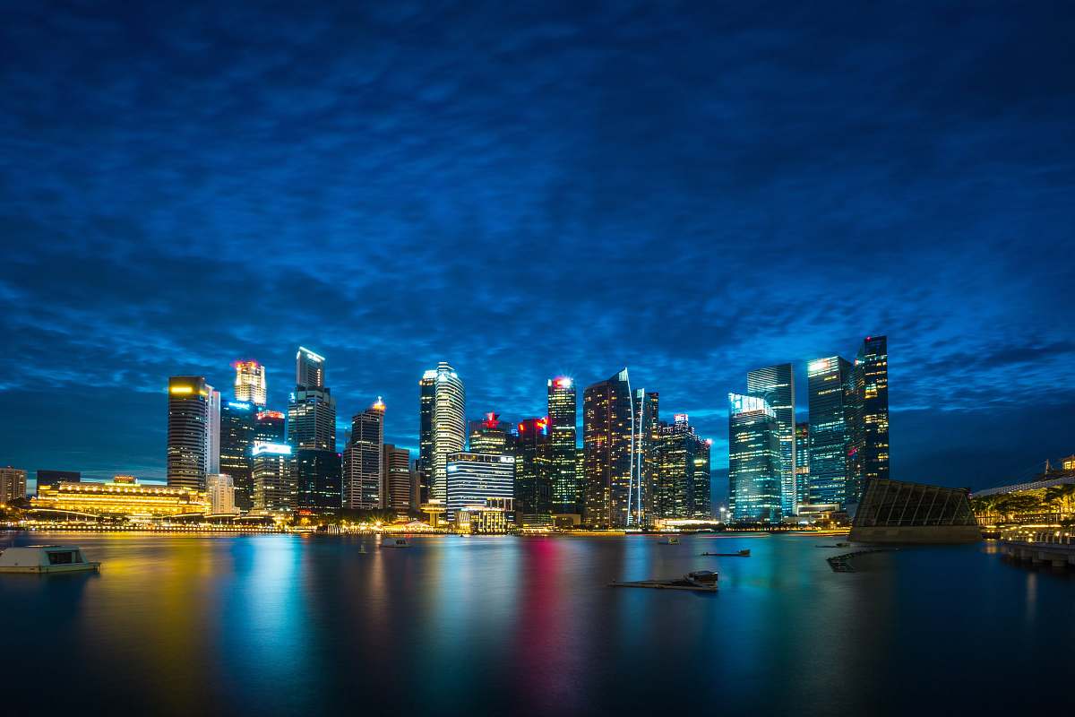 city city buildings beside body of water under cloudy sky singapore